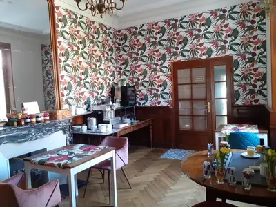 a room with a table and a wall with floral wallpaper at Hotel Sainte Anne - Apt in Apt