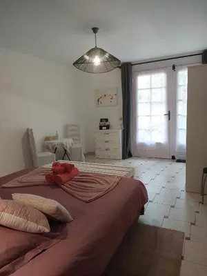 a bedroom with a bed with a stuffed animal on it at Mas des Cigognes in Le Thor