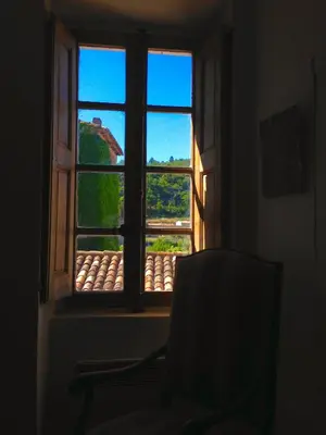 a chair in front of a window with a view at Suite Provençale in Saignon