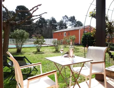 a table and two chairs on a patio at Hotel Les Ambres in Roussillon