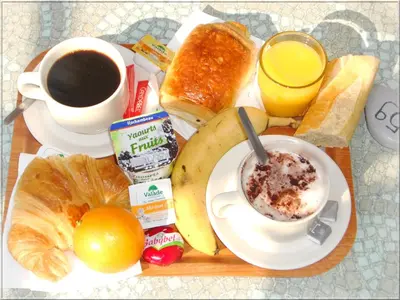 a plate of breakfast food with a cup of coffee and bread at Aix Hotel in Aix-en-Provence