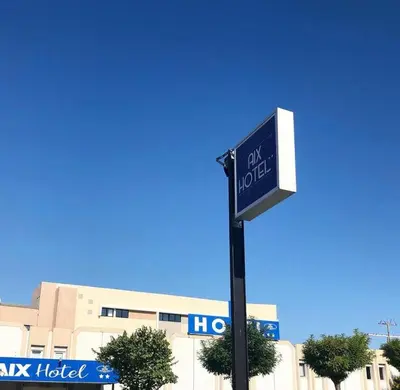 a street sign for a hotel in front of a building at Aix Hotel in Aix-en-Provence