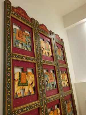 a red cabinet with paintings of elephants on it at Gite A.M Hoche in Lançon-Provence