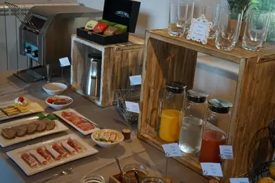 a table topped with different types of food and drinks at Les Terrasses du Luberon in Bonnieux