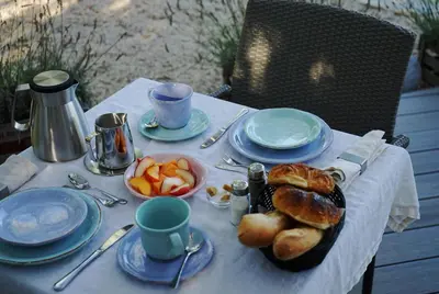 a table with a plate of bread and pastries on it at Les Terrasses du Luberon in Bonnieux