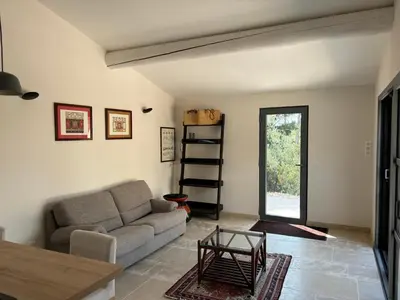 a living room with a couch and a table at le Mas des Pignes -adults only in Aix-en-Provence