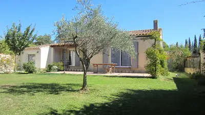 a small tree in a yard in front of a house at Studio A Grans in Grans