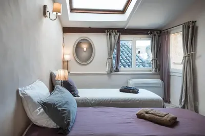 a bedroom with two beds and a window at Su Lei Campanes in Lauris