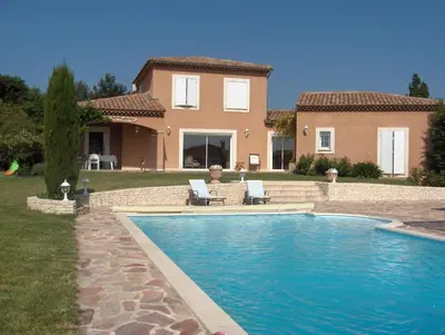 a house with a swimming pool in front of a house at Villa Eglantine in Caumont-sur-Durance