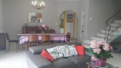 a living room with a couch and a table at Villa Eglantine in Caumont-sur-Durance