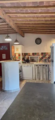 a kitchen with white appliances in a room at Gîte Mas de la Restanque in Monteux