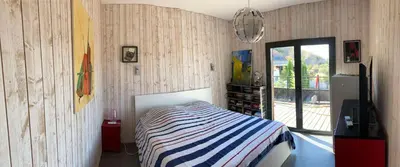 a bedroom with a bed with a striped blanket at Belle villa en Provence in Lançon-Provence