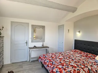 a bedroom with a bed and a table and a mirror at Villa Les Angevines by Interhome in Morières-lès-Avignon