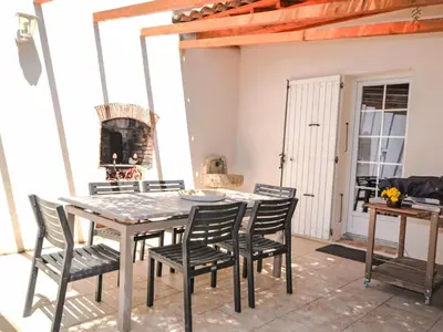 a dining room with a table and chairs and a fireplace at Villa Les Angevines by Interhome in Morières-lès-Avignon