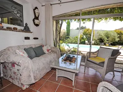 a living room with a couch and a table at Villa Les Angevines by Interhome in Morières-lès-Avignon