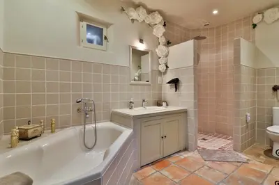 a bathroom with a tub and a sink and a toilet at Gite des Carmes and Spa in Le Thor