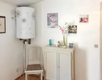 a small kitchen with a table and a refrigerator at Maison charmante à Vachères avec vue sur la montagne in Vachères