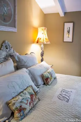 a bedroom with a bed with pillows and a lamp at Domaine de Mejeans - Teritoria in Alleins