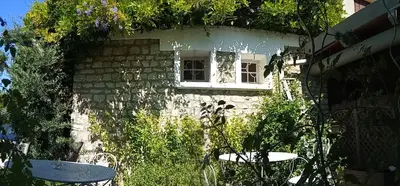 a small house with a window and plants on it at Hotel Font De Lauro in Saumane-de-Vaucluse