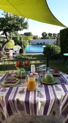 a table with a table cloth with food on it at Hotel Font De Lauro in Saumane-de-Vaucluse