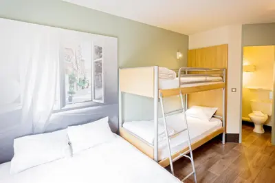 a room with two bunk beds and a window at B&B HOTEL Aix-en-Provence Pont de l'Arc in Aix-en-Provence