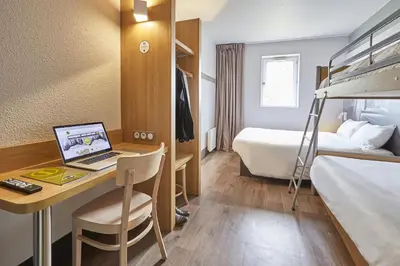 a hotel room with a laptop computer on a desk at B&B HOTEL Aix-en-Provence Pont de l'Arc in Aix-en-Provence