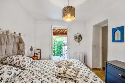 a bedroom with a bed with a pillow on it at Maison de village in Bonnieux