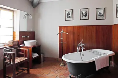 a bathroom with a tub and a sink and a toilet at La Maison Sur La Sorgue - Esprit de France in LʼIsle-sur-la-Sorgue
