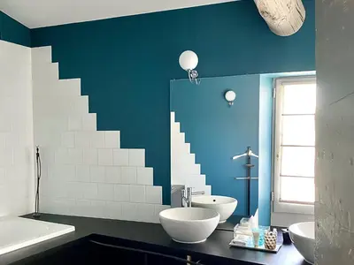 a bathroom with two sinks and a staircase on the wall at La Maison Sur La Sorgue - Esprit de France in LʼIsle-sur-la-Sorgue