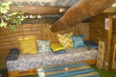 a couch sitting in the corner of a cabin at Lou mas li Pitchoun 