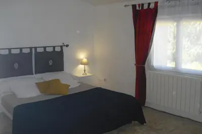 a bedroom with a bed and a window at Lou mas li Pitchoun 