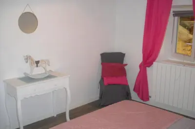 a room with a bed and a desk and a window at Lou mas li Pitchoun 