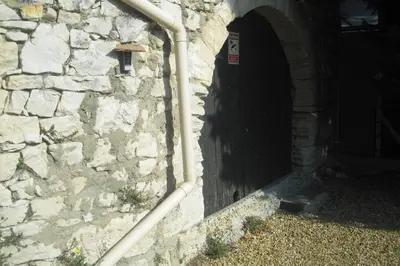 a stone wall with a tunnel and a pipe at Lou mas li Pitchoun 