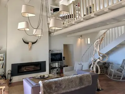 a living room with a couch and a fireplace at Mas La Bellevue in Murs