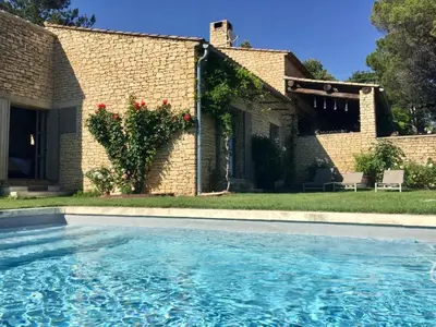 a swimming pool in front of a house at Mas La Bellevue in Murs