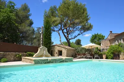 a swimming pool in front of a house at Le Jas des Parpaillous in LʼIsle-sur-la-Sorgue