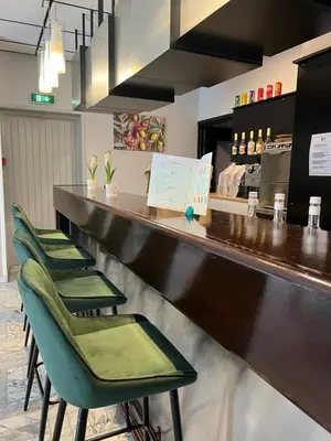 a lobby with a reception desk and a tile floor at Adonis Arc Hotel Aix in Aix-en-Provence