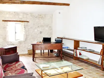 a living room with a piano and a glass table at Maison de charme à Mollégès avec piscine privée in Mollégès
