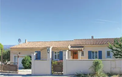 a house with blue doors and a fence at 4 Bedroom Beautiful Home In Goult in Goult