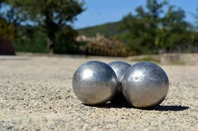 three metal balls sitting on the ground at L instant Magique in Beaumont-de-Pertuis