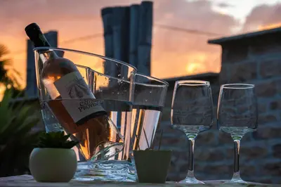 a bottle of wine sitting on a table with two glasses at L instant Magique in Beaumont-de-Pertuis