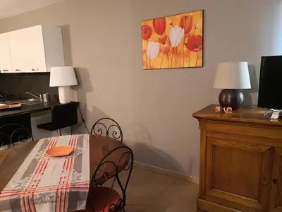 a dining room with a table and chairs and a desk at Bastidon Provencal in Gordes