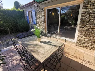 a patio with a table and chairs on a patio at Bastidon Provencal in Gordes