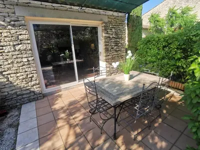 a patio with a table and chairs on a patio at Bastidon Provencal in Gordes