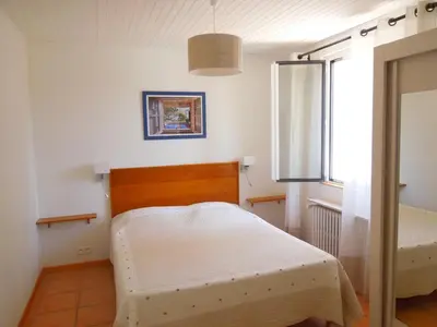 a bedroom with a bed and a window at Villa - La Luberonne in Lourmarin