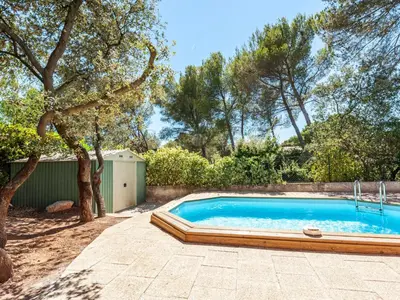 a swimming pool in a yard with a tree at Apartment Mireio by Interhome in Lambesc