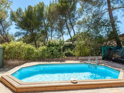 a swimming pool in a yard with a fence and trees at Apartment Mireio by Interhome in Lambesc