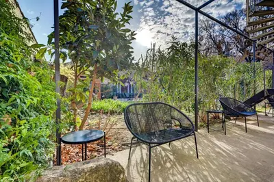 a group of chairs and tables in a garden at Hôtel Paul in Aix-en-Provence