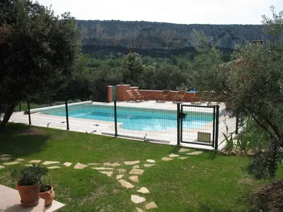 a swimming pool with a fence in a yard at Ll POULIDETTO in Lioux
