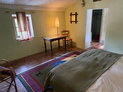 a bedroom with a bed and a table with a lamp at Belle de Nuit in Oppède